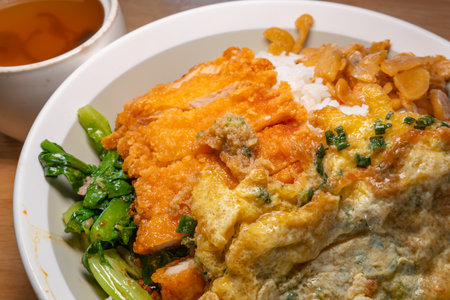 angle view deep fried chicken fillet and fried egg rice with pork tripe and red date soup at horizontal compositionの写真素材