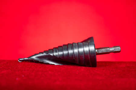 conical step drill bit on red