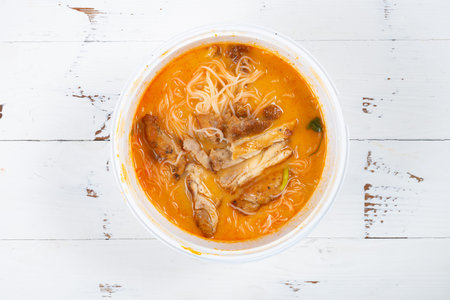 top view bowl of Tom Yum chicken chop rice noodles at horizontal composition
