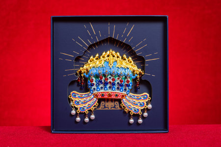 ZHONGSHAN China-November 12 2025: an ornate traditional Chinese headdress adorned with gold and pearls and gemstones.のeditorial素材