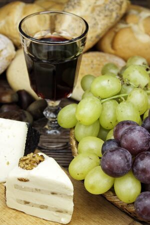 Red wine with some olives,cheese and bread an ideal appetizer.の写真素材