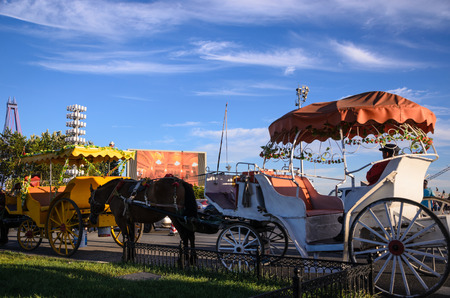 Dalian, China - September 8, 2014: Two horse carriages stopped in XingHai Park for tourists, on...