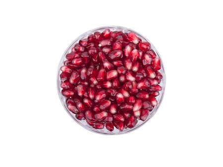 Pomegranate seeds in glass vase on a white backgroundの写真素材