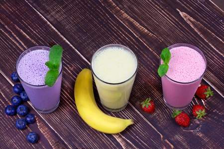 Strawberry, banana and blueberries milkshakesの写真素材