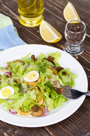 Fresh salad with mushrooms, squid and quail eggsの写真素材