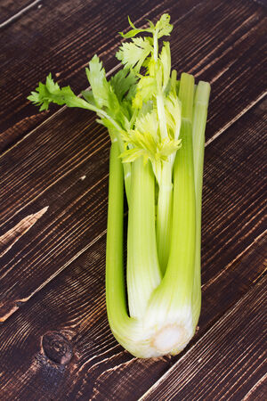 Organic vegetables - celery with leaves on wooden backgroundの写真素材
