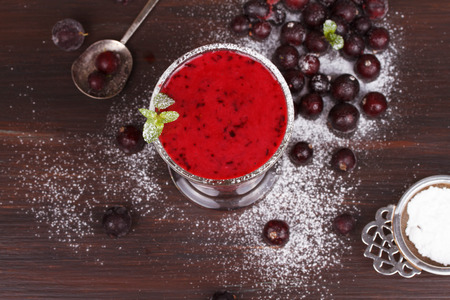 Frozen black currant berries smoothie with mintの写真素材