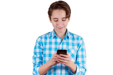 Teenager is typing a message in phone, isolated on white backgroundの写真素材