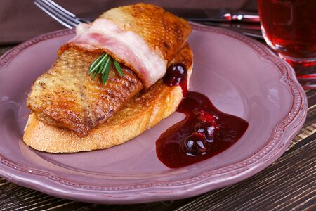 Roasted duck breast fillet with bacon, black currant and wine sauceの写真素材