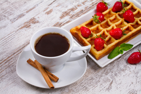 Cup of coffee, Belgium waffle and strawberriesの写真素材