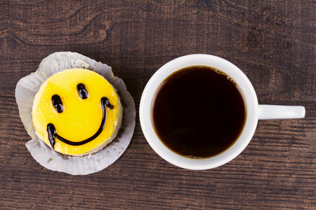 Coffee cup and smile cakeの写真素材