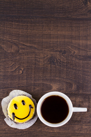 Coffee cup and smile cakeの写真素材