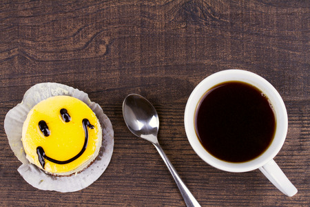 Coffee cup and smile cakeの写真素材