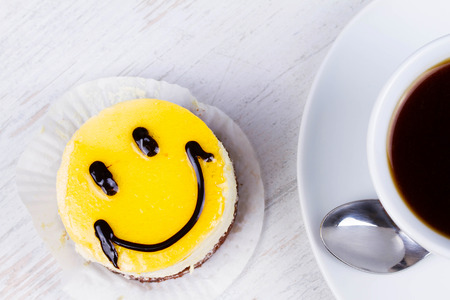 Coffee cup and smile cakeの写真素材