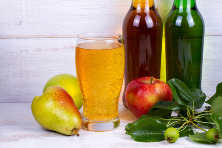 Glass and bottles of ciderの写真素材