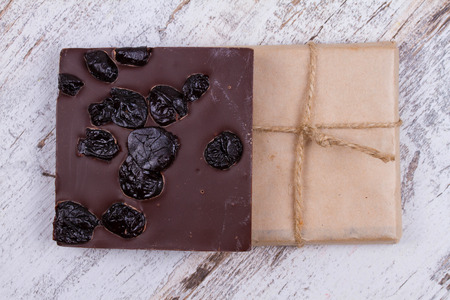 Chocolate bars and strawberries on wooden backgroundの写真素材