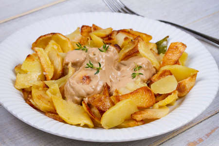 Chicken breasts in mushroom creamy sauce and home fried potatoesの写真素材
