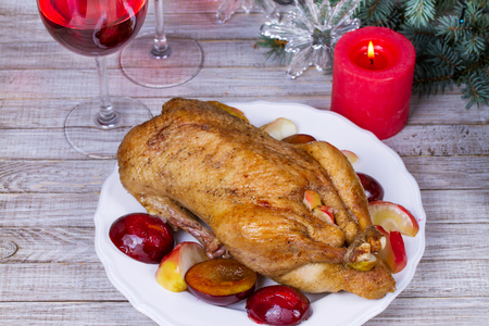Roast duck with plums and applesの写真素材