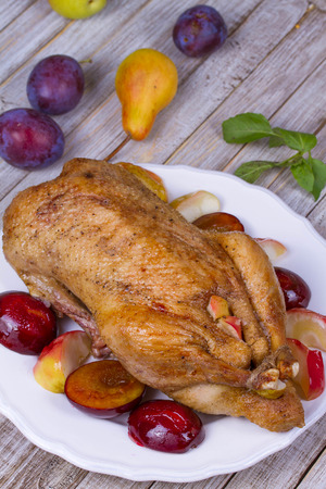 Roast duck with plums and applesの写真素材