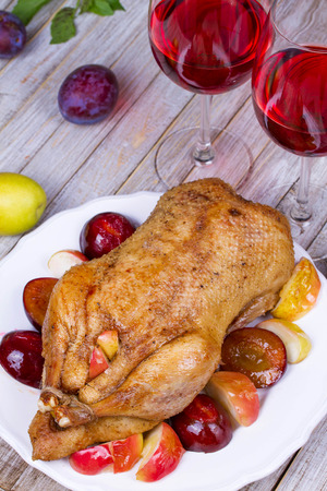 Roast duck with plums and applesの写真素材