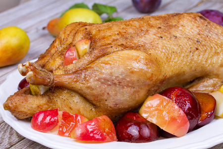 Roast duck with plums and applesの写真素材