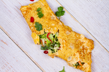 Filled Omelette with Onion, Carrot, Avocado, Cabbage Coriander, Chilli, Yoghurt; View from above, Studio Shotの写真素材