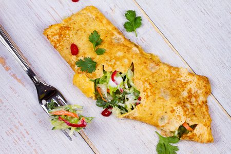 Filled Omelette with Onion, Carrot, Avocado, Cabbage Coriander, Chilli, Yoghurt; View from above, Studio Shotの写真素材
