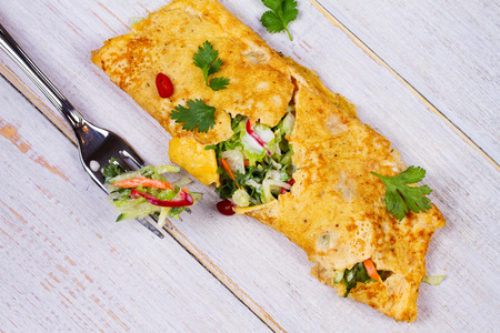 Filled Omelette with Onion, Carrot, Avocado, Cabbage Coriander, Chilli, Yoghurt; View from above, Studio Shotの写真素材
