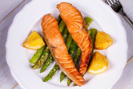 Broiled Salmon with Asparagus and Lemon. View from above, top studio shotの写真素材