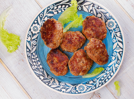 Beef and Pork Patties in Blue Plate. View from above, top studio shotの写真素材