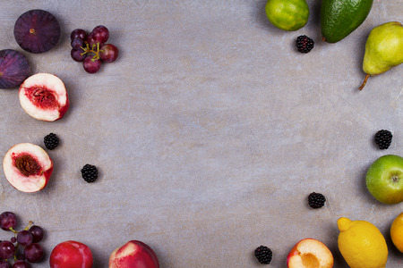 Figs, lemon, lime, plums, grape, blackberries, avocado, apples, pears and peaches. View from above, top studio shot of fruits. Fruit still life. Clean eating concept. Colorful food collageの写真素材