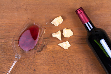 Glass and bottle of red wine with parmesan. Wine and cheese still life. View from above, top studio shotの写真素材