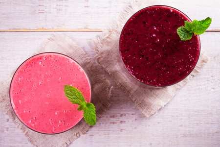 Summer berries smoothie garnished with mint. View from above, top studio shotの写真素材