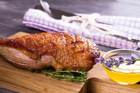 Duck breast, lavender honey and thyme, served on chopping boardの写真素材