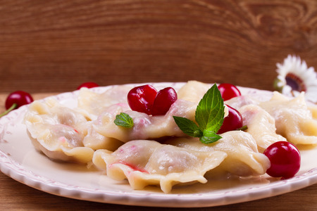 Dumplings, filled with cherries. Varenyky, vareniki, pierogi, pyrohy - popular dish in East Europe. Horizontalの写真素材