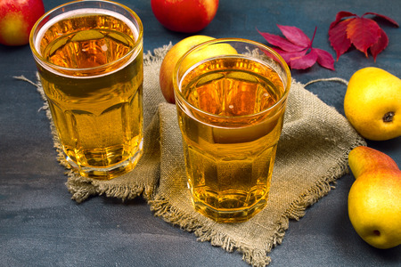 Cider with fruits. Glasses of cider with apples and pears. Food and drink concept, horizontal. Lightly tonedの写真素材