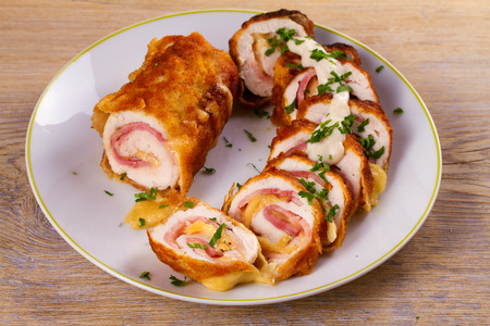 Chicken breasts with cheese and bacon. Crispy, creamy chicken wraps, horizontalの写真素材
