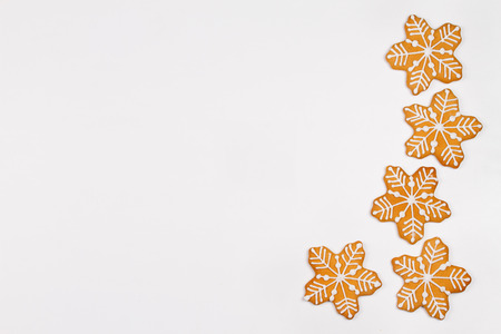 Ginger bread cookies on white background. Gingerbread cookie snowflakes. Christmas, New Year and winter holidays concept. View from above, top, horizontalの写真素材