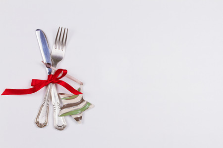 Christmas table place setting with cutlery, pine branch and ribbon. Winter holidays and festive background. Christmas eve dinner, New Year food lunch. View from above, top, horizontalの写真素材