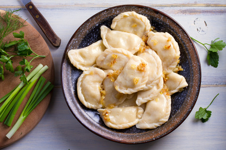 Plate of pierogi or varenyky, vareniki, Dumplings, filled with potato. Pyrohy - dumplings with filling. View from above, top, overhead  の写真素材