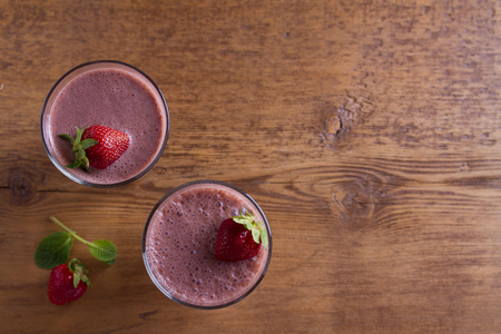 Milkshake with chocolate and strawberries. Chocolate strawberry smoothie. View from above, top studio shotの写真素材