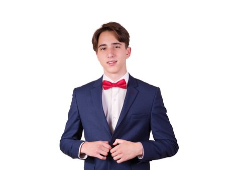 Portrait of elegant young man in suit and bow tie, isolated on white backgroundの写真素材