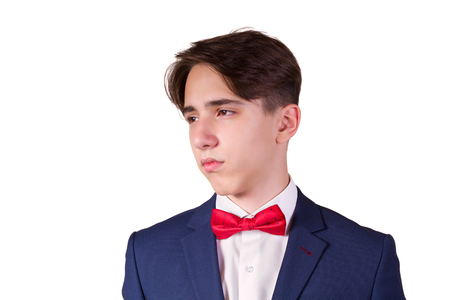 Portrait of elegant young man in suit and bow tie, isolated on white backgroundの写真素材