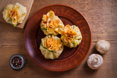 Savory crepes with mushrooms and onion. Bags of pancakes stuffed with mushrooms. overhead, horizontalの写真素材