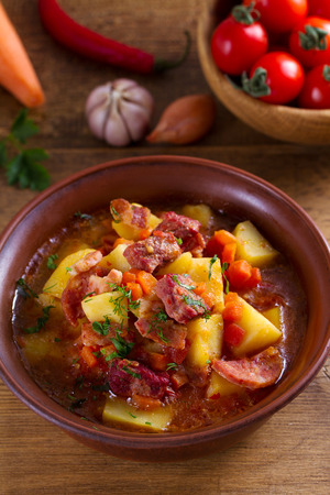 Goulash soup bograch in a bowl. Hungarian dish. Stew, made with beef, bacon, sausages, potatoes and carrotsの写真素材