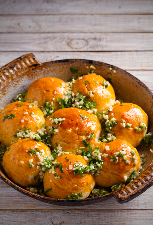 Garlic bread, buns. Bread rolls with garlic and parsley. verticalの写真素材