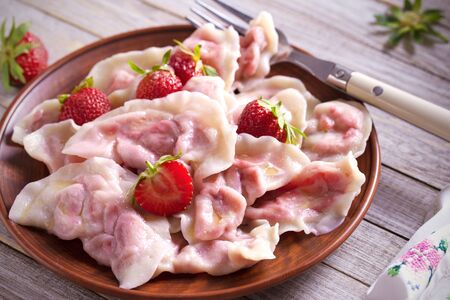 Dumplings, filled with strawberries. Varenyky, vareniki, pierogi, pyrohy. Diet vegetarian foodの写真素材