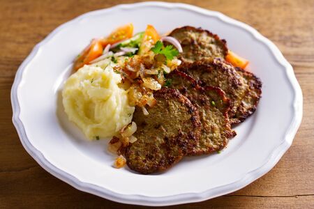 Beef liver pancakes with mashed potato and vegetables. Liver side dishの写真素材