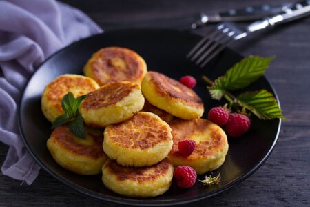 Cottage cheese pancakes. Syrniki and raspberriesの写真素材