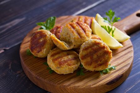 Fish cakes. Fish patties. Fried cutlets of minced fish on serving boardの写真素材